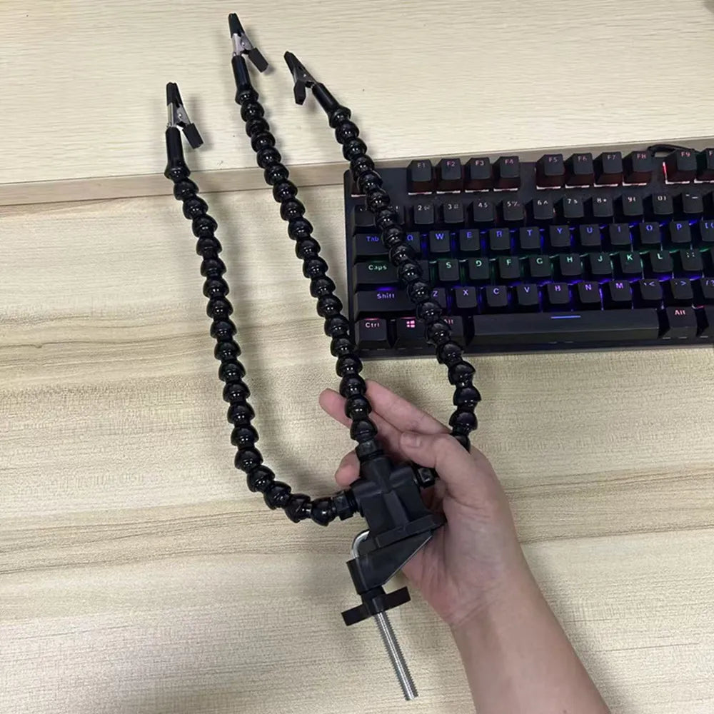 Third hand soldering station clamped to a desk, holding wire clear of a keyboard